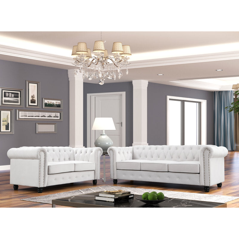 Luxury white Chesterfield 2 piece tufted sofa set of 5 with nailhead trim in elegant living room interior